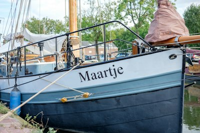 a blue and white boat docked at a dock