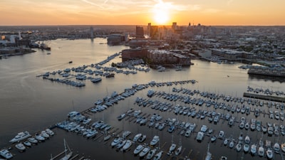 a harbor filled with lots of boats at sunset