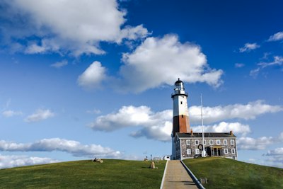 white and black lighthouse under blue sky during daytime