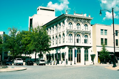A large white building sitting on the corner of a street