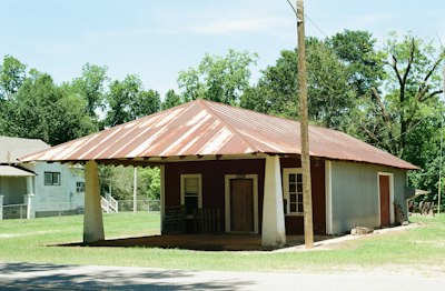 Old building with a rusty metal roof and porch