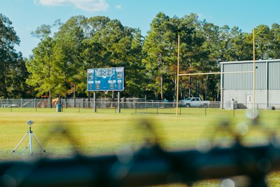 A view of a baseball field through a fence