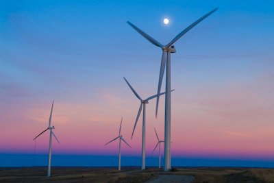 five windmills in front of ocean