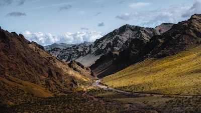 A scenic view of a valley with mountains in the background