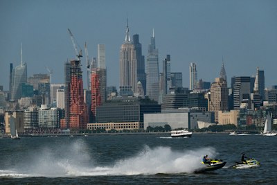 Jetskis race in front of the new york city skyline