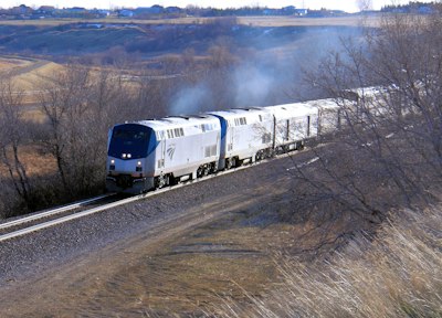 white and blue train on rail road during daytime