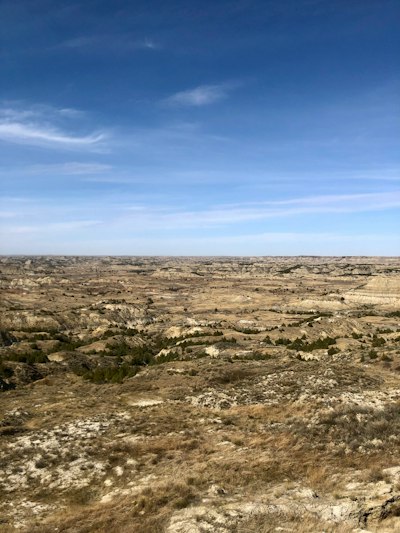 a large open field with a sky background
