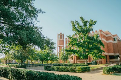 a college campus with a clock tower in the background