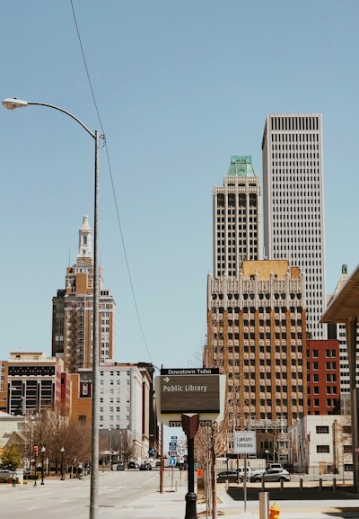 a city street with tall buildings in the background