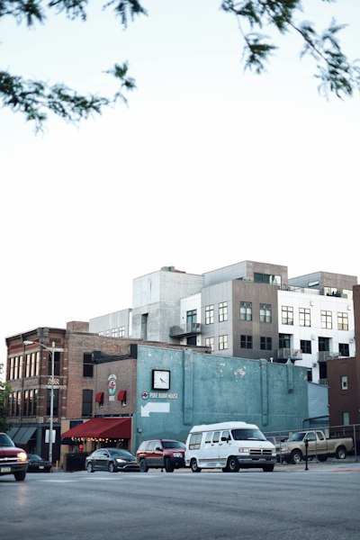 cars parked beside brown concrete building during daytime