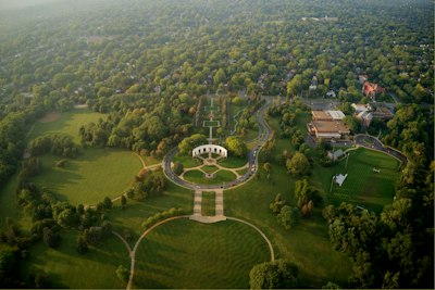 an aerial view of a circular building surrounded by trees