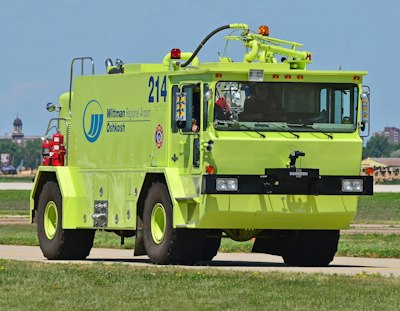 green and red fire truck on road during daytime