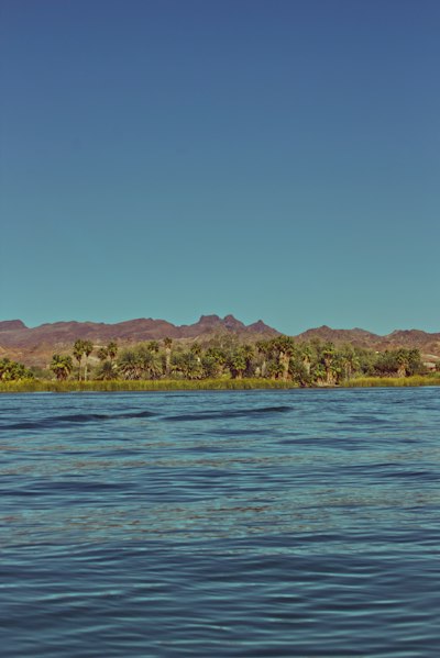 a body of water with mountains in the background