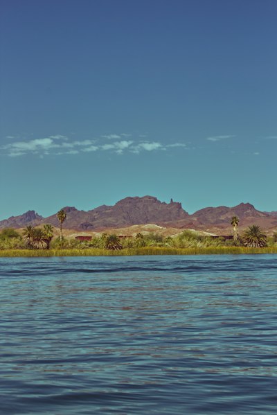 a body of water with mountains in the background