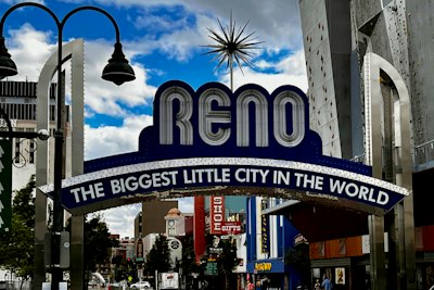 a city street with a sign that says reno the biggest little city in the world