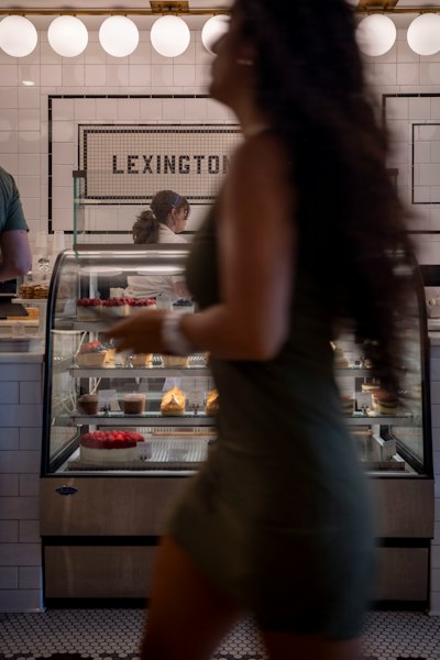Woman walks past a bakery display
