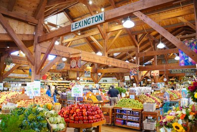 Interior of a bustling farmers market with abundant fresh produce