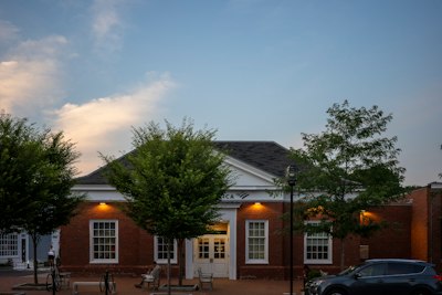 Brick building with white trim and trees