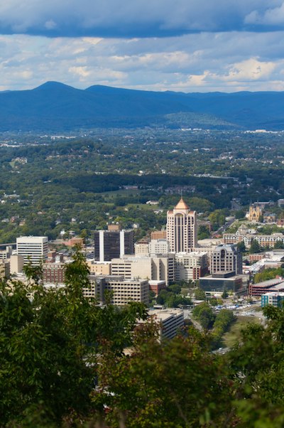 City skyline nestled among green rolling hills