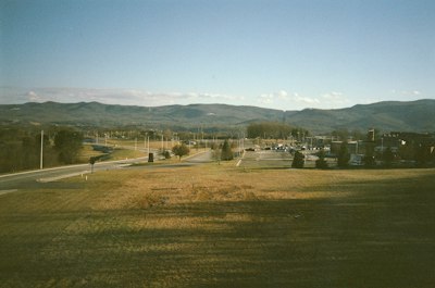 white and black house near green grass field during daytime