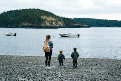 2 women and 2 men standing on shore during daytime