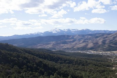a view of a valley with mountains in the background
