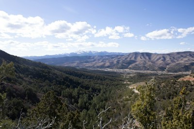 a view of a valley with mountains in the background