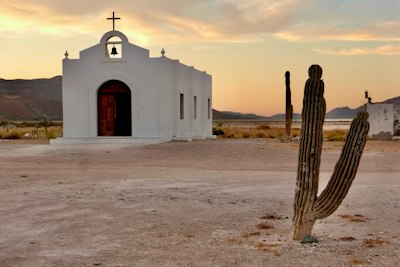 Church sits among cacti in a desert landscape