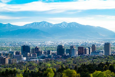 city skyline across green mountain during daytime