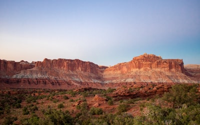A scenic view of a desert with a mountain in the background