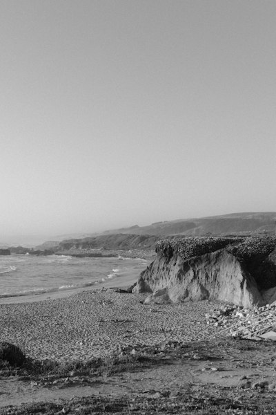 a black and white photo of a rocky beach