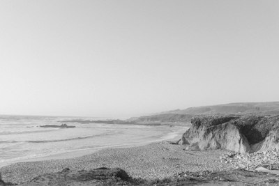 a black and white photo of a beach
