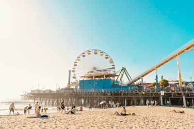 photo of yellow and white Ferris Wheel and seashore
