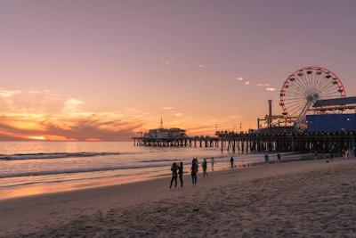 people walking on beach during sunset