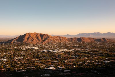 an aerial view of a city with mountains in the background