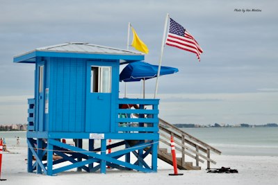 A lifeguard stand on the beach with an american flag