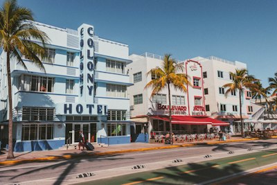 A large white building with palm trees in front of it