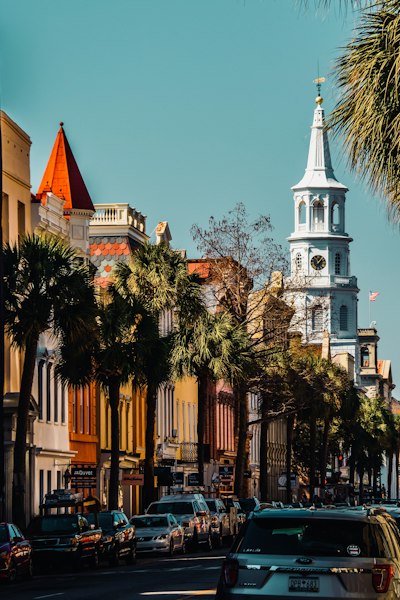 a city street with a church steeple in the background