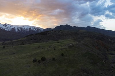 The sun is setting over a mountain range