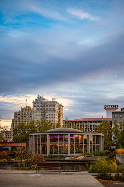 A park with benches and buildings in the background