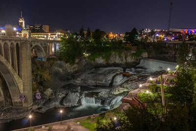 water falls near bridge during night time
