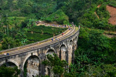 a group of people riding bikes on a bridge