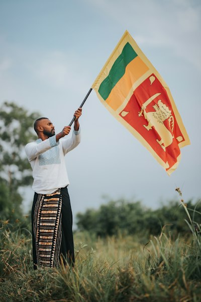 a man holding a flag in a field