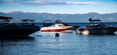 a group of boats floating on top of a lake