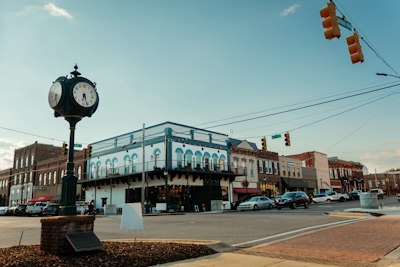 a clock on a pole in a city
