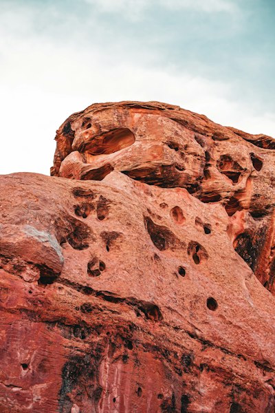 a rock formation with holes in the middle of it