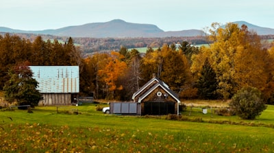 Autumn farm scene with a barn and covered bridge