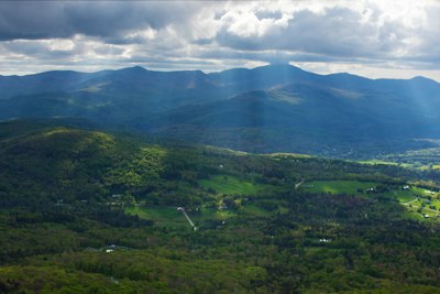 a view of a valley with mountains in the background