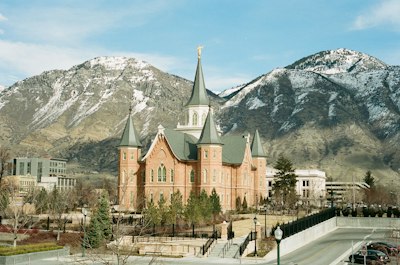 brown and gray concrete building near mountain under blue sky during daytime