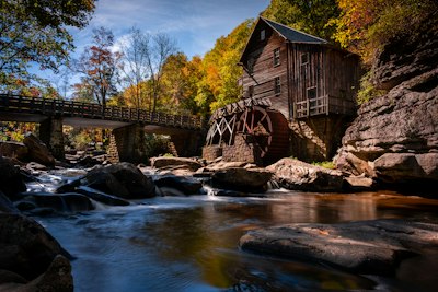 a river runs under a wooden bridge